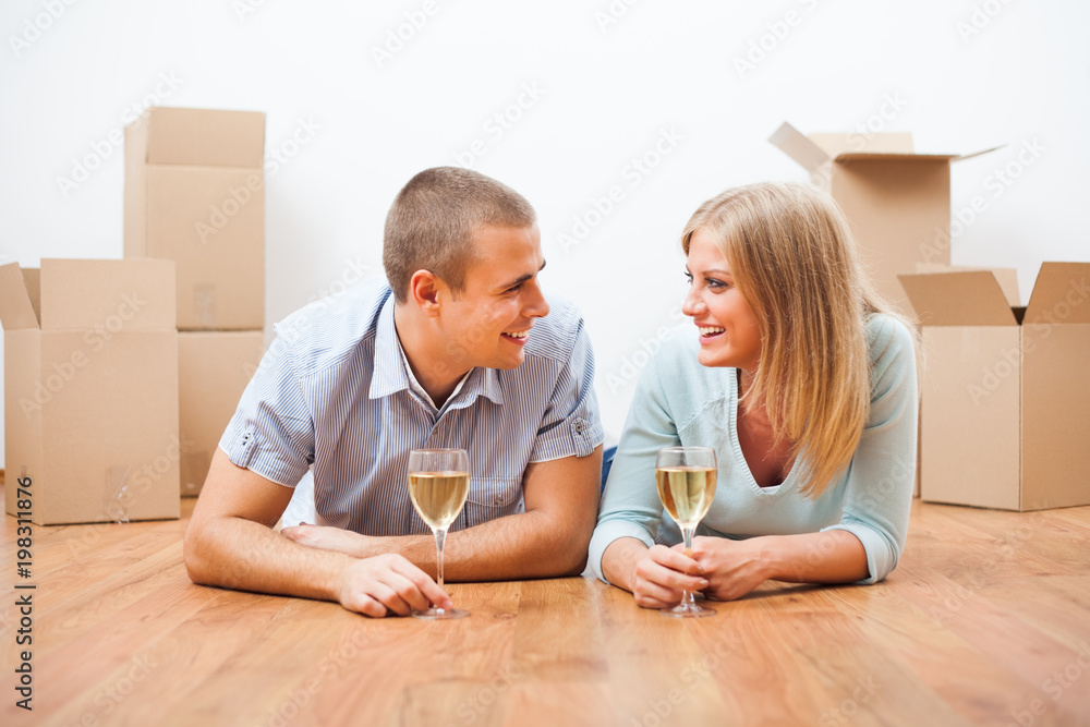 Young couple is moving to their new home. It's time for celebration. 