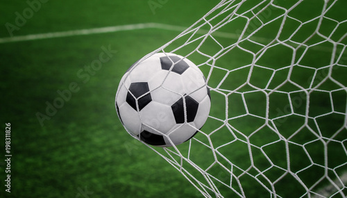 Soccer ball on goal with net and green background © anekoho
