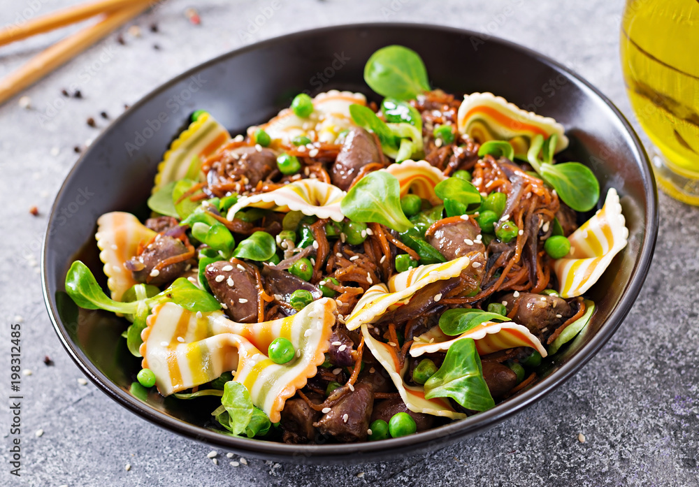 Chicken hearts with carrots in sweet and sour sauce with farfalle pasta. Healthy salad Chicken hearts with carrots in sweet and sour sauce with farfalle pasta. Healthy salad