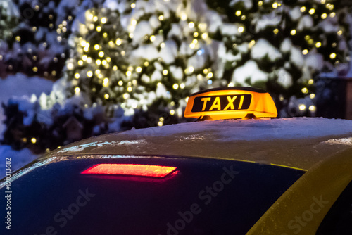 Taxi sign on the background of night winter city