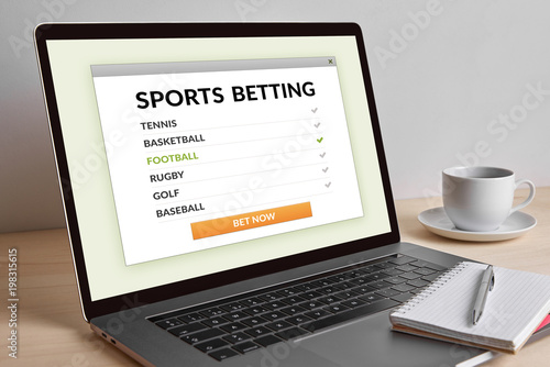 Sports betting concept on modern laptop computer screen on wooden table. All screen content is designed by me. 