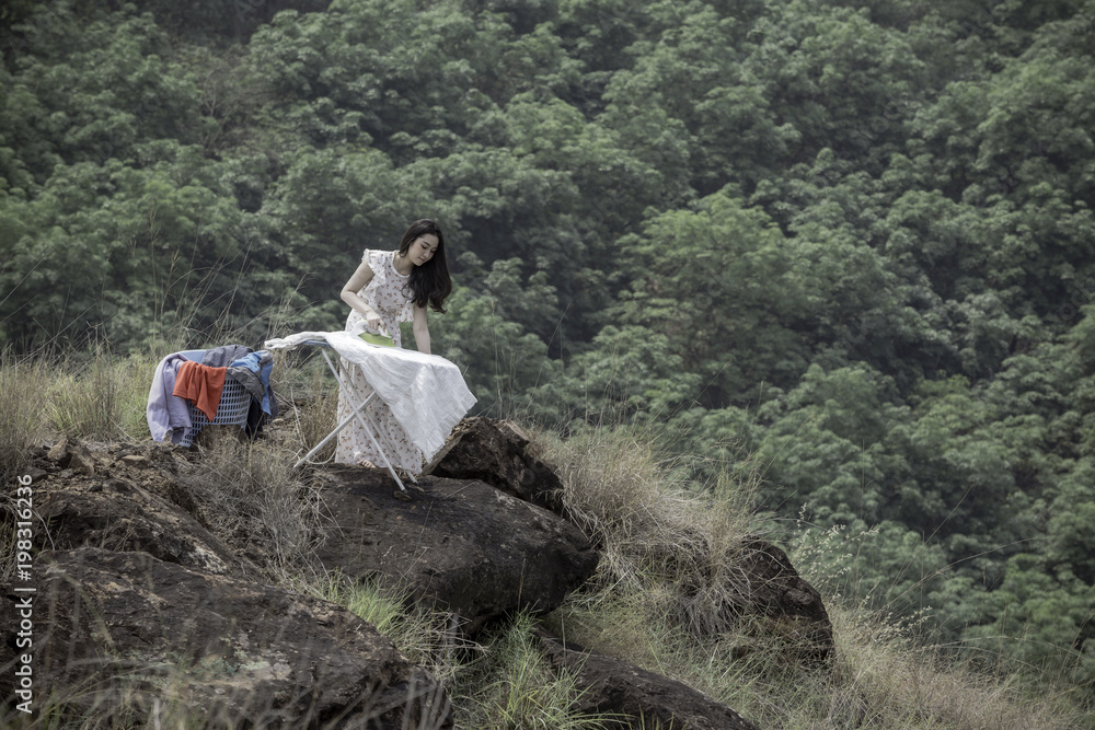 Ironing of housewives On the rocks on the cliffs on the mountain. The concept of world conservation.