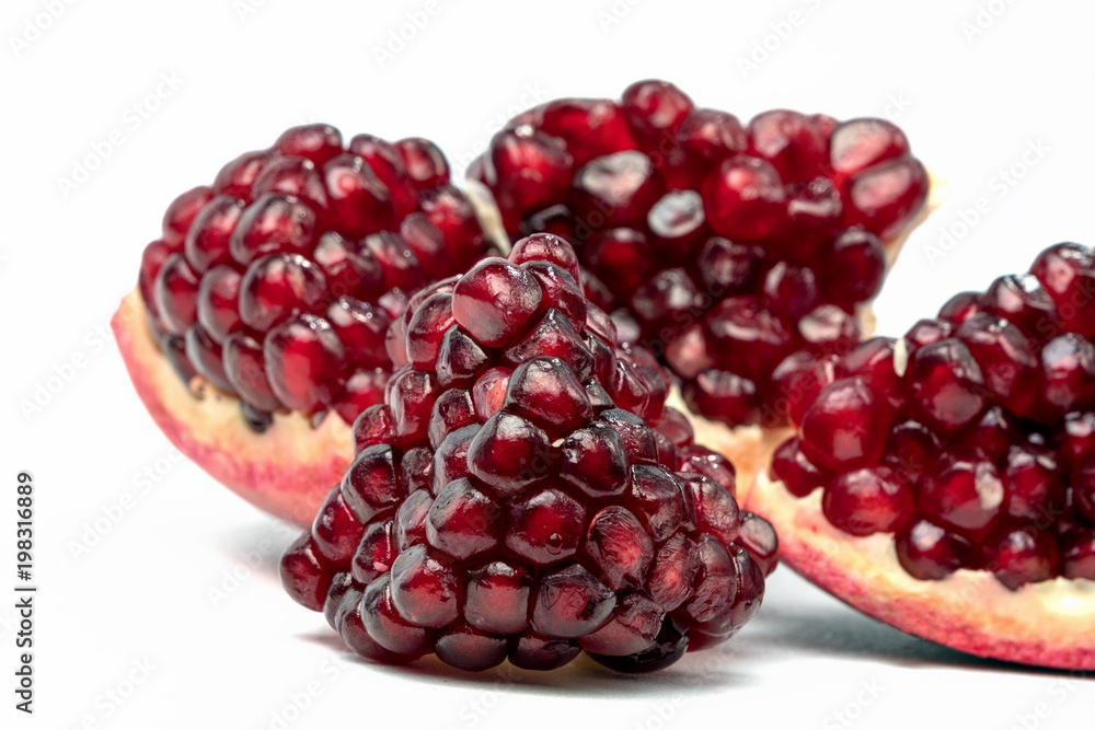 Fruits of Red Ripe Pomegranate on the White Background. Fruits of Red Ripe Pomegranate on the White Background.