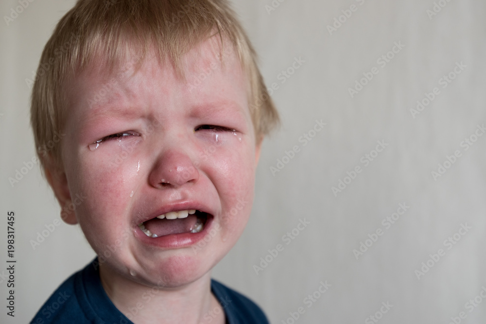 Cry. Portrait of boy. Caucasian child looks at camera. Charming boy the kid cries with tears in his eyes. an angry temper. hysterics. Cry. Portrait of boy. Caucasian child looks at camera. Charming boy the kid cries with tears in his eyes. an angry temper. hysterics.