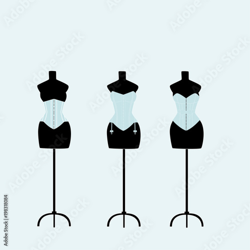 several light mannequins with corsets on a light blue background
