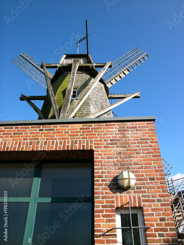 Backsteinfassade des Feuerwehrhaus in der alten Sinninger Mühle vor blauem Himmel im Sonnenschein in Sinningen bei Saerbeck im Kreis Steinfurt in Westfalen im Münsterland photo