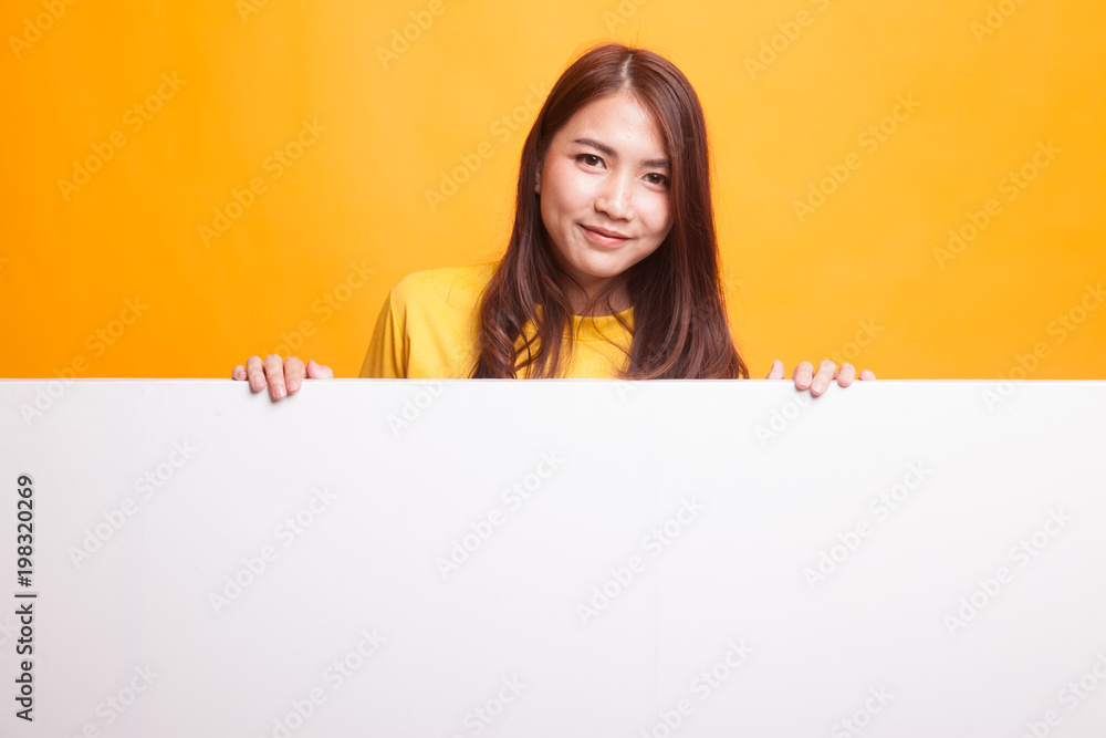Young Asian woman with blank sign in yellow dress Young Asian woman with blank sign in yellow dress