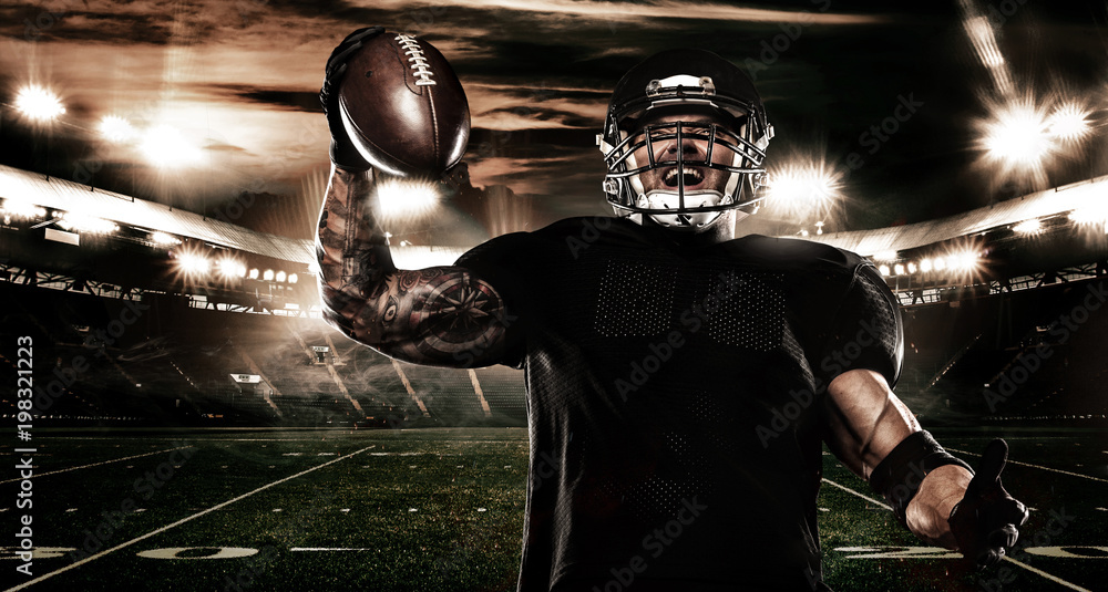 Fototapeta American football sportsman player on stadium. Sports banner and wallpaper with copyspace.