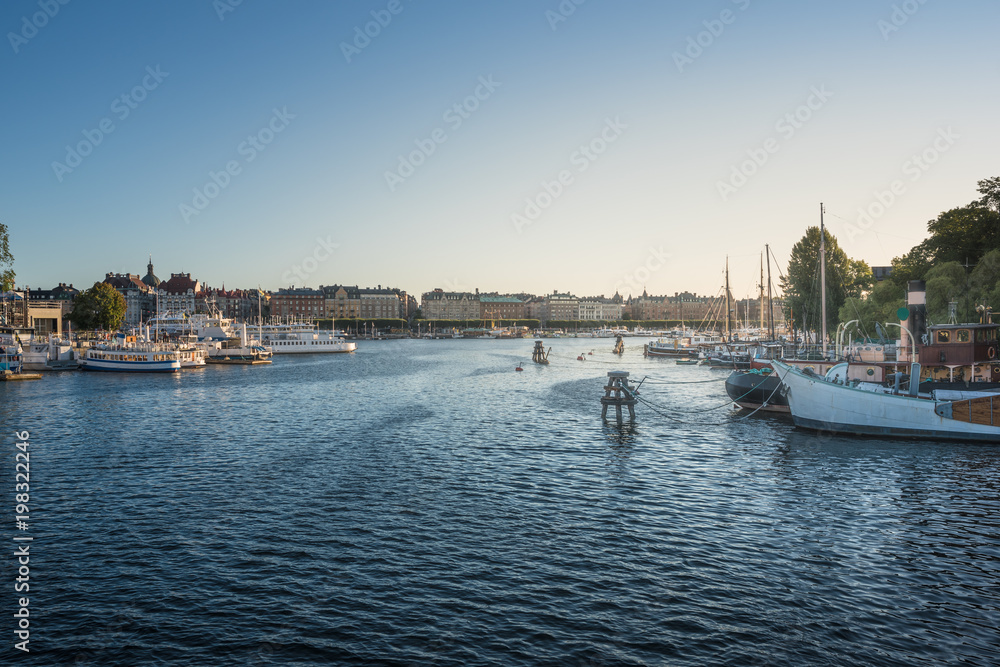 View at the harbor with parked ships in Stockholm at sunrise. View at the harbor with parked ships in Stockholm at sunrise.