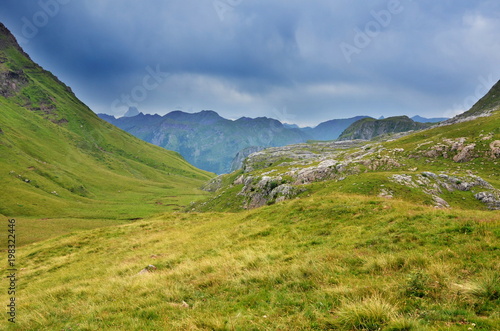 Hiking trail in the mountains through meadows