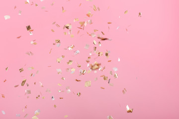 Golden confetti on pink background