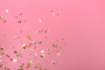 Golden confetti on pink background