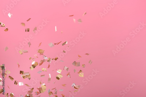 Fototapeta Naklejka Na Ścianę i Meble -  Golden confetti on pink background