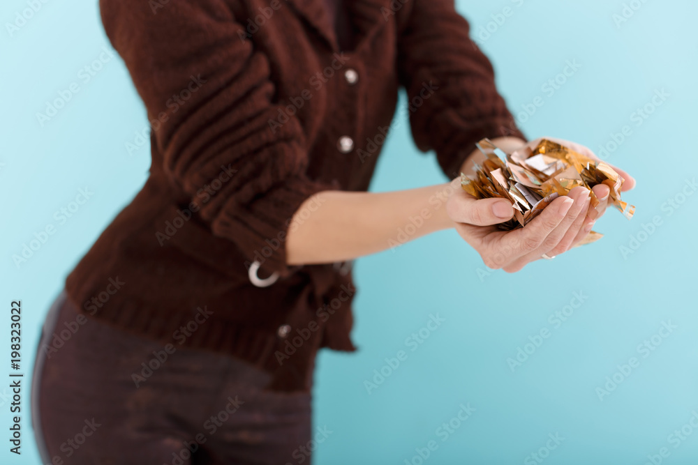 woman hand holding golden confetti woman hand holding golden confetti