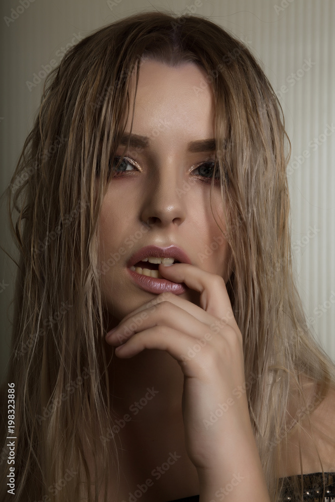 Fashion portrait of sexy blonde woman with long wet hair and naked shoulders Fashion portrait of sexy blonde woman with long wet hair and naked shoulders