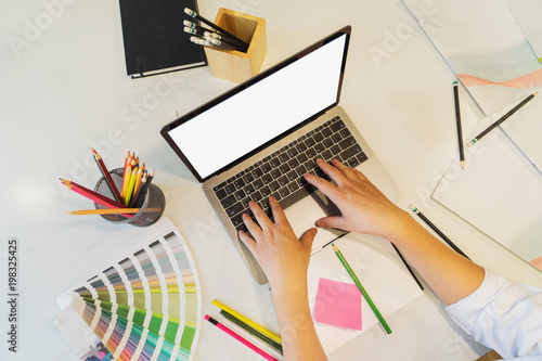 Graphic designer working at studio desk,top view.