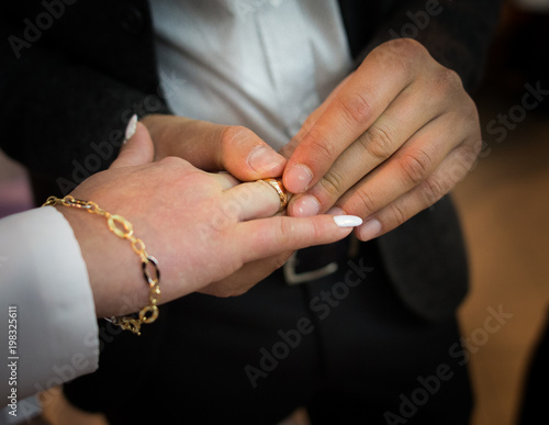 hands of bride and groom with wedding rings