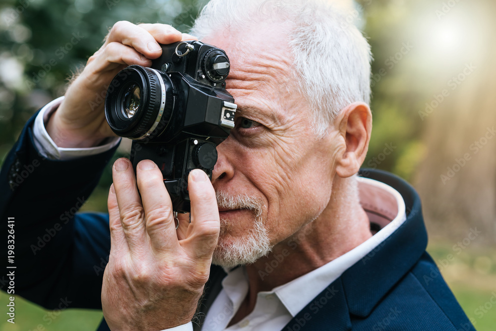 Mature man taking pictures, light effect Mature man taking pictures, light effect