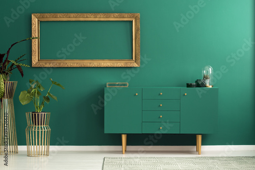 Modern sideboard and golden decorations photo