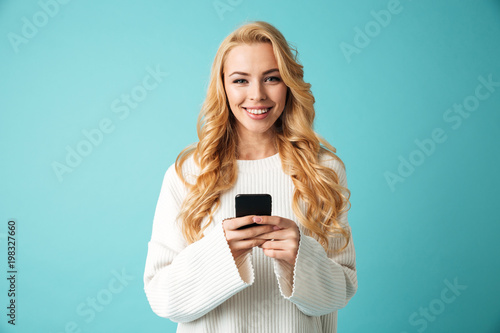 Portrait of a beautiful young blonde woman in sweater