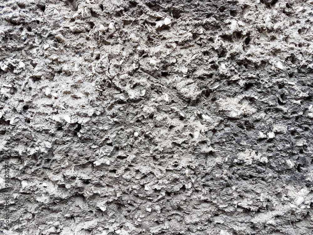 Gray relief texture of wall. Embossed concrete with expressive pattern. Decoration of exterior and interior. Styreets buildings. Artistic object. The lava of the volcano is silvery. Gray relief texture of wall. Embossed concrete with expressive pattern. Decoration of exterior and interior. Styreets buildings. Artistic object. The lava of the volcano is silvery.