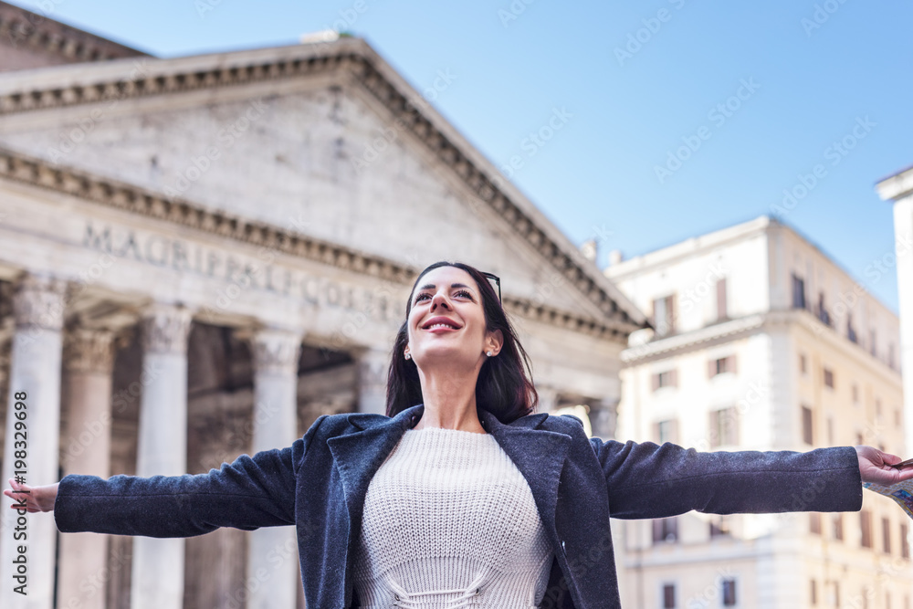 Suscessful tourist woman celebrates with open arms and smile at Pantheon in Rome