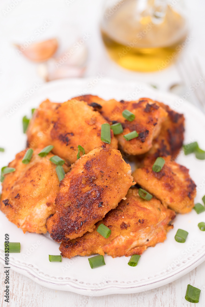 fried chicken on white plate on wooden background fried chicken on white plate on wooden background