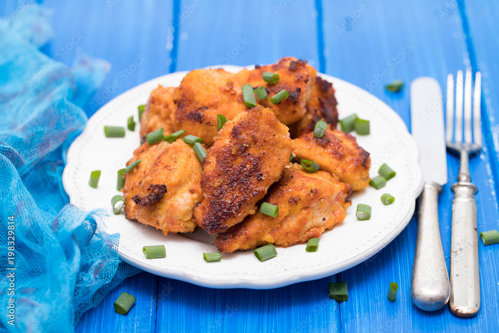 fried chicken on white plate on wooden background fried chicken on white plate on wooden background