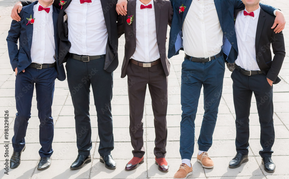 Groom and his friends pose in a restaurant Groom and his friends pose in a restaurant