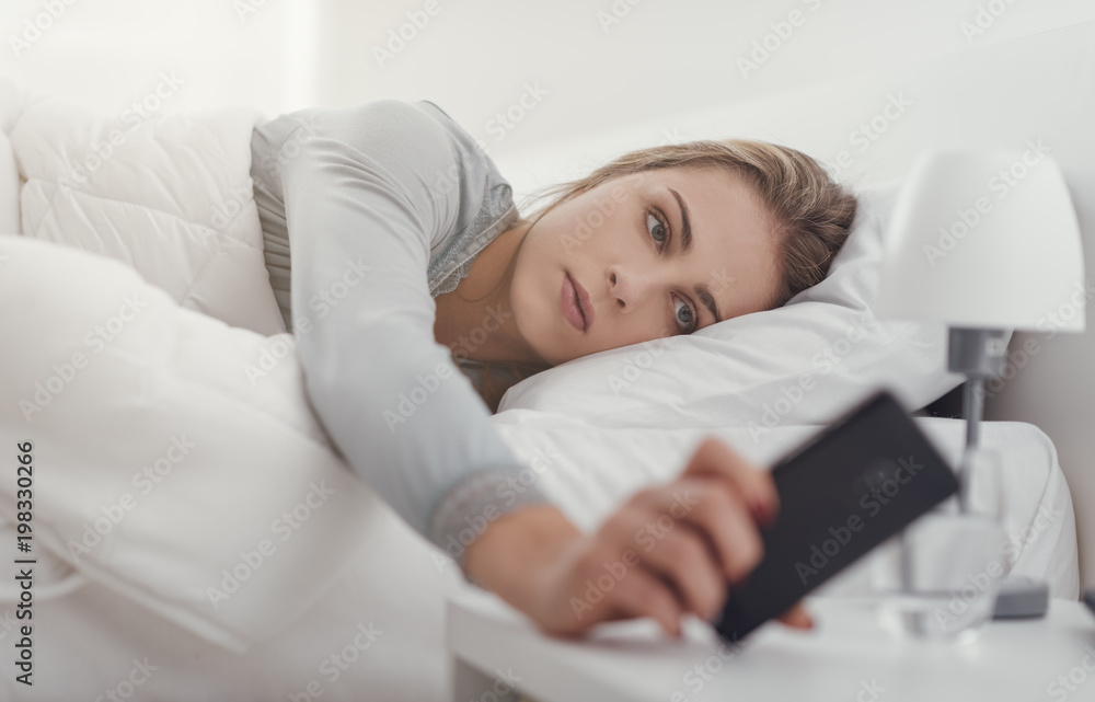 Woman checking messages on her smartphone Woman checking messages on her smartphone