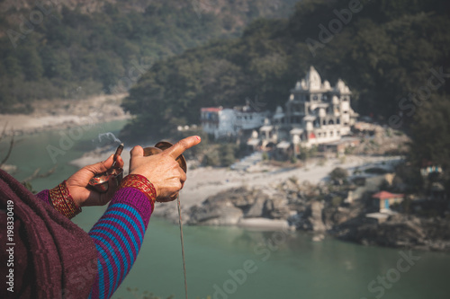 Woman with incense in hand making Puja photo