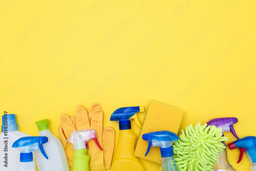 Spring cleaning spray bottle products on a bright yellow background Spring cleaning spray bottle products on a bright yellow background