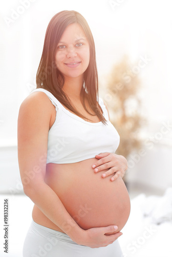 portrait of young pregnant woman on a light background. Free Download portrait of young pregnant woman on a light background. - GFXLoad