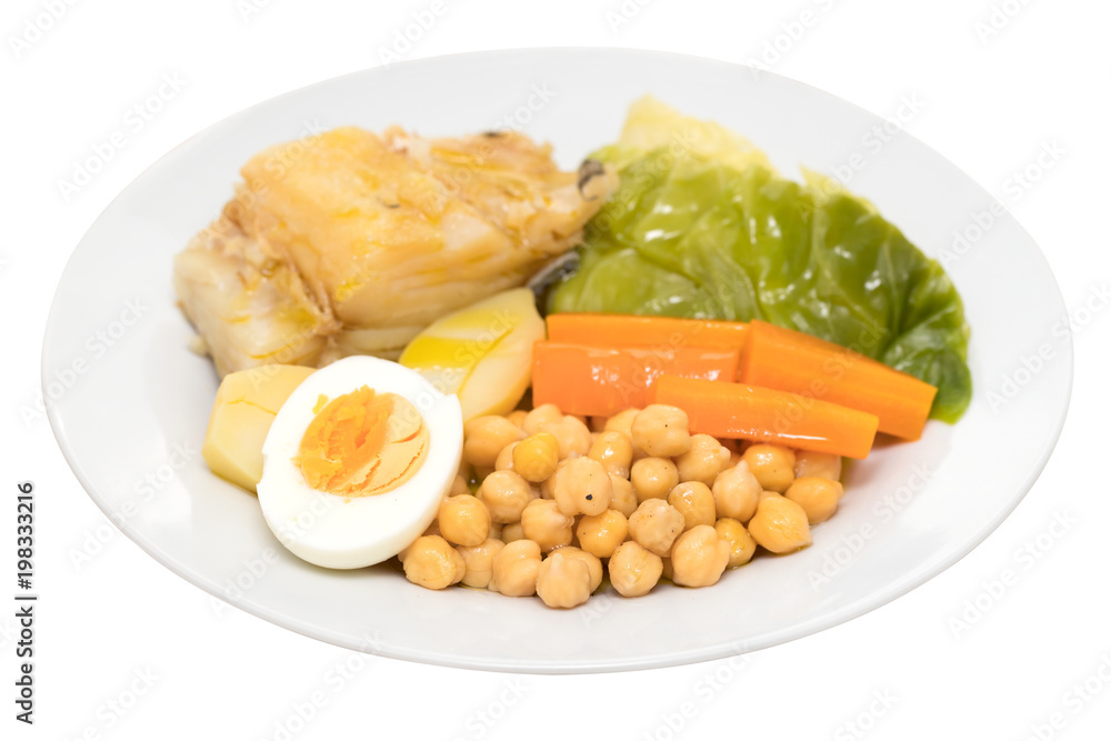 boiled cod fish with potato, carrot, cabbage , chick-pea and egg on white plate