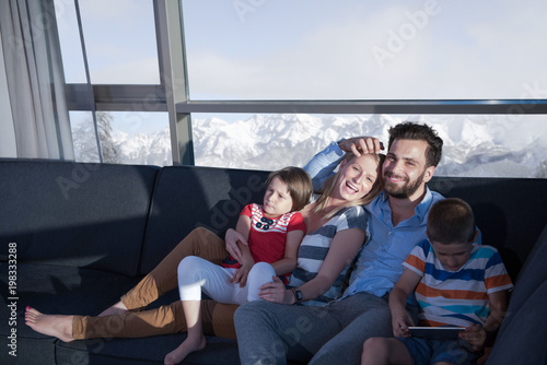 happy young couple spending time with kids at home