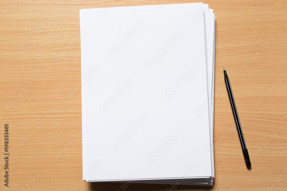 White business card on wooden table. Blank portrait A4. White business card on wooden table. Blank portrait A4.