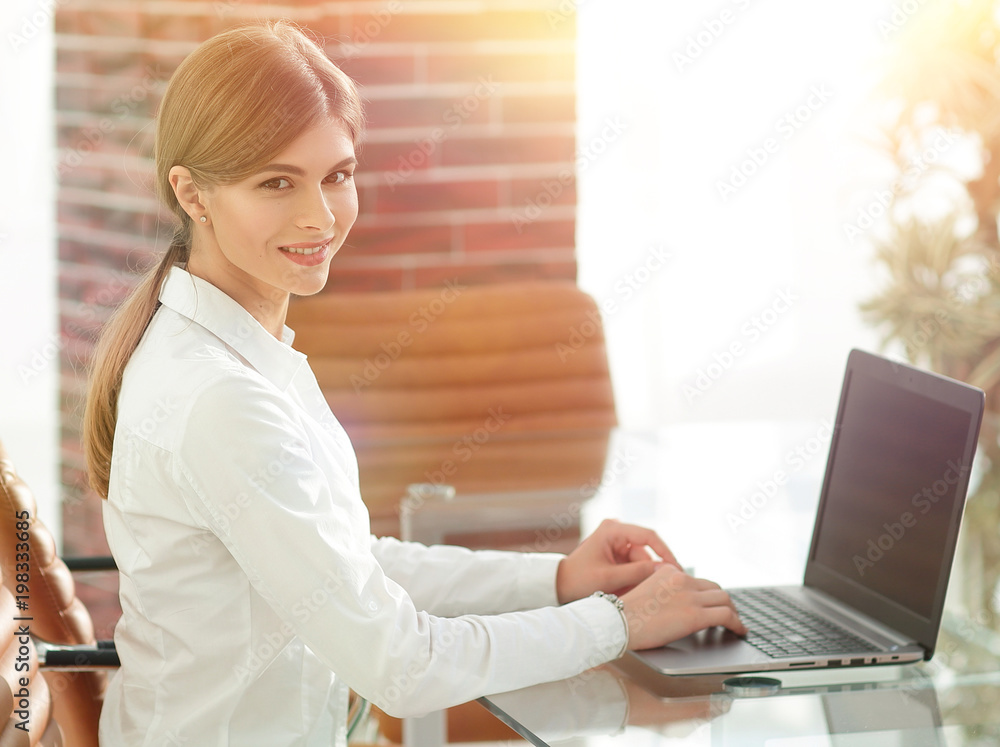 portrait of young woman working with a laptop . portrait of young woman working with a laptop .