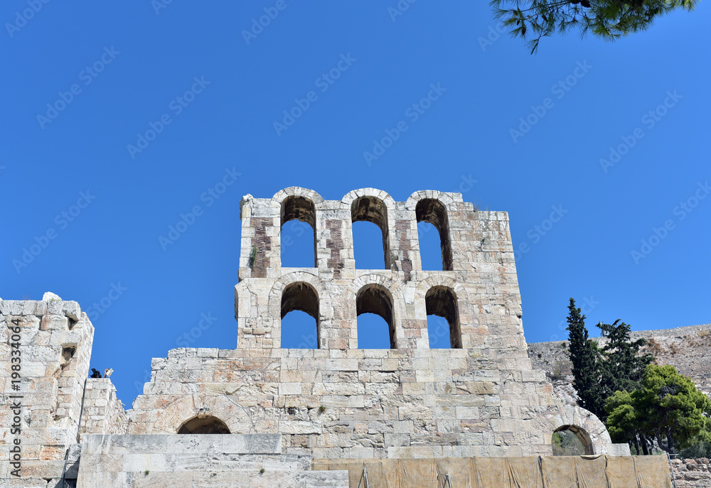 Ancient arches of the Roman theater on the Acropolis in Athens Greece against a beautiful blue sky 