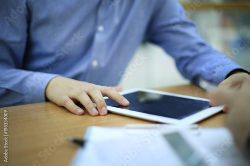 close up hands multitasking man using tablet, laptop connecting wifi