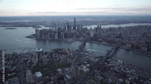 New York City wide angle aerial view of Brooklyn and Lower Manhattan while flying over the Brooklyn Bridge and Manhattan Bridge. photo