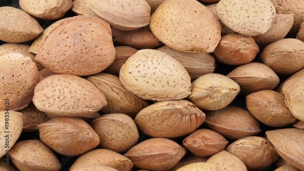 Almonds on grey stone background, close-up Almonds on grey stone background, close-up