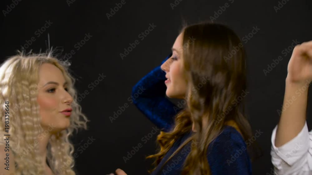 entertainment, night life and people concept - happy friends dancing at party or disco over black background entertainment, night life and people concept - happy friends dancing at party or disco over black background