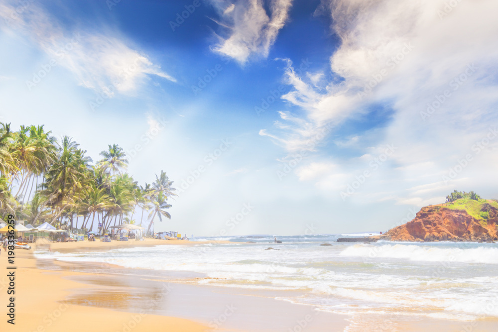 Straw hat, sunglasses, slippers and a bag on the golden sand of Sri Lanka's beach Straw hat, sunglasses, slippers and a bag on the golden sand of Sri Lanka's beach