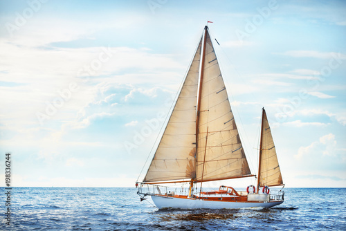 Billede på lærred Old expensive vintage two-masted sailboat (yawl) close-up, sailing in an open sea