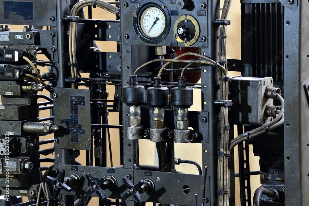 Fototapeta premium Hydraulics oil station on the machine tool on industrial equipment. Lubrication system with oil under pressure.