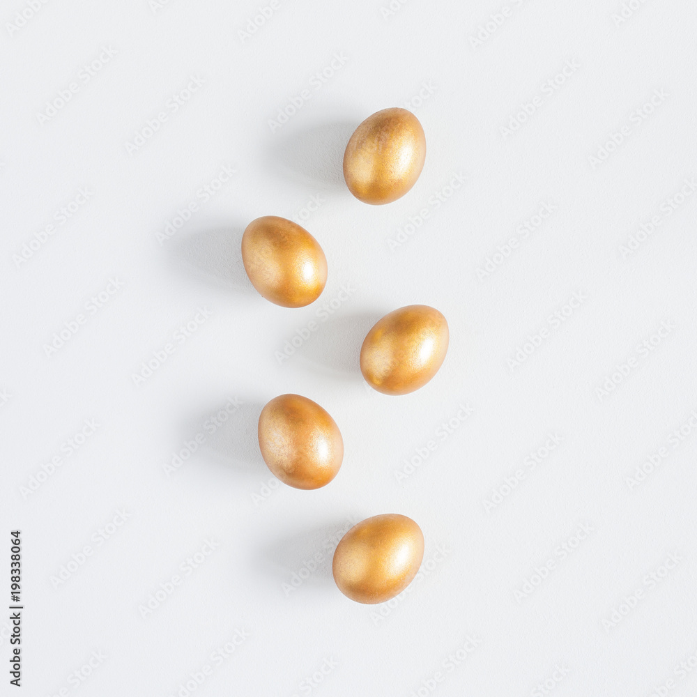 Easter golden eggs on gray background. Easter concept. Flat lay, top view, square