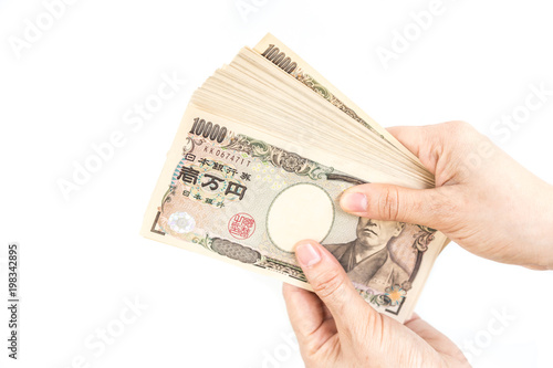 Hand hold a Japanese currency, isolated on white background