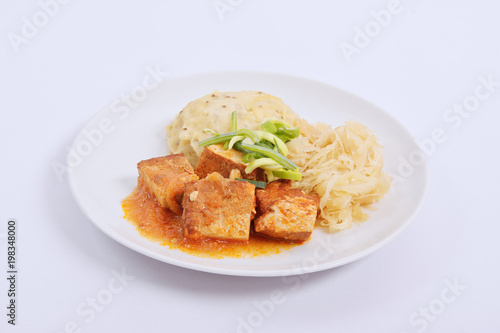 Tofu with cabbage and rice dumplings on a white
