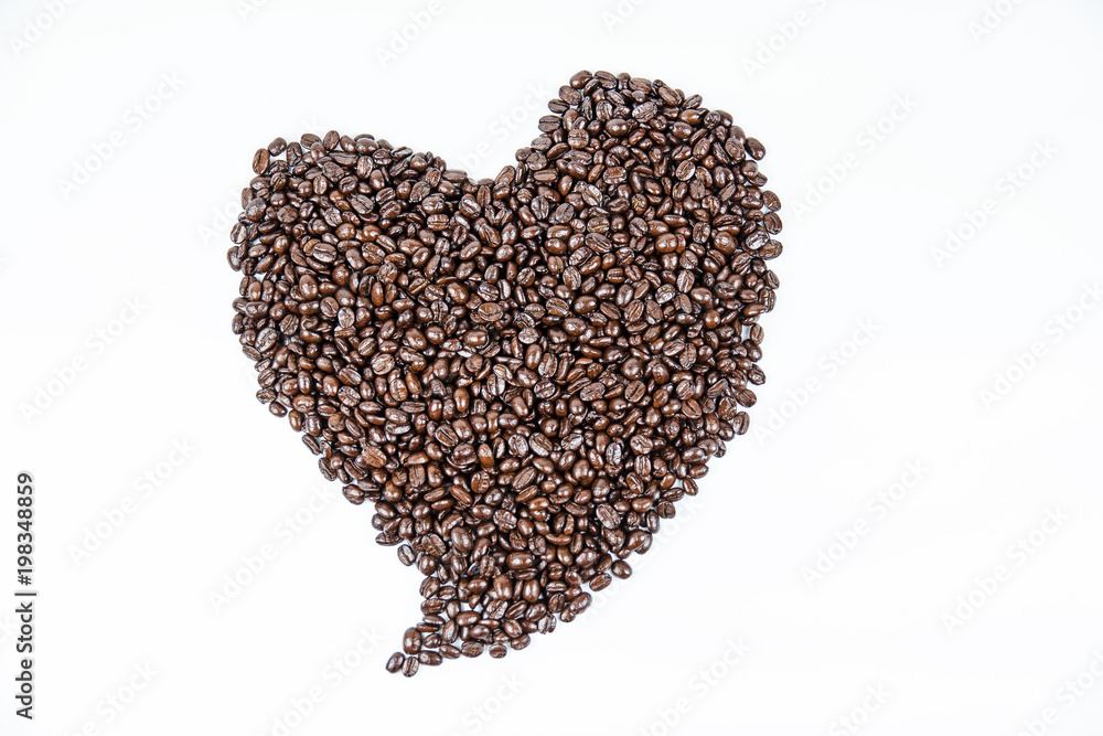 Closeup heart pattern was made by roasted coffee beans,on white background. Closeup heart pattern was made by roasted coffee beans,on white background.