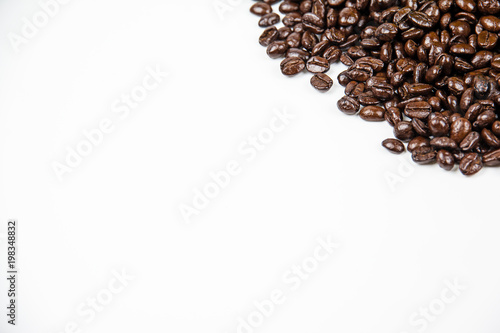 The roasted coffee beans put at the corner top right of white background,blurry light around.